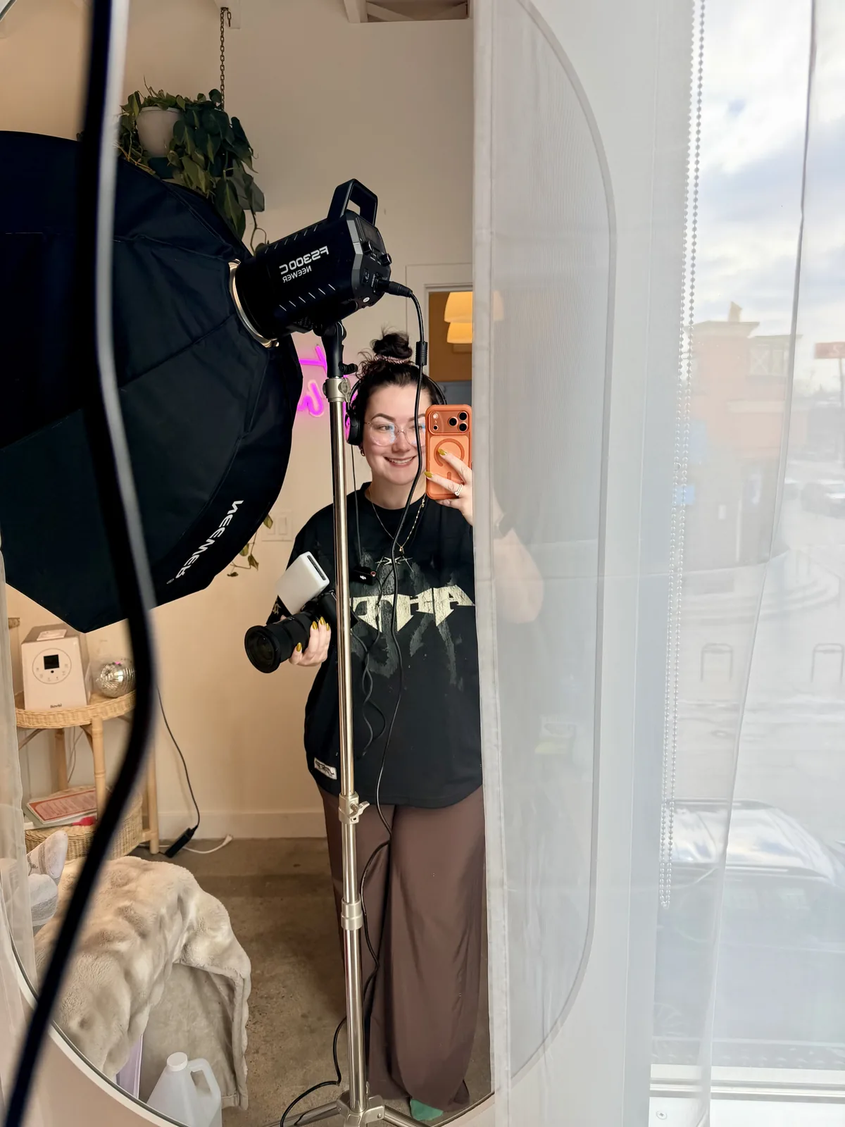 Softbox and light stand set up in a studio, reflected in a mirror