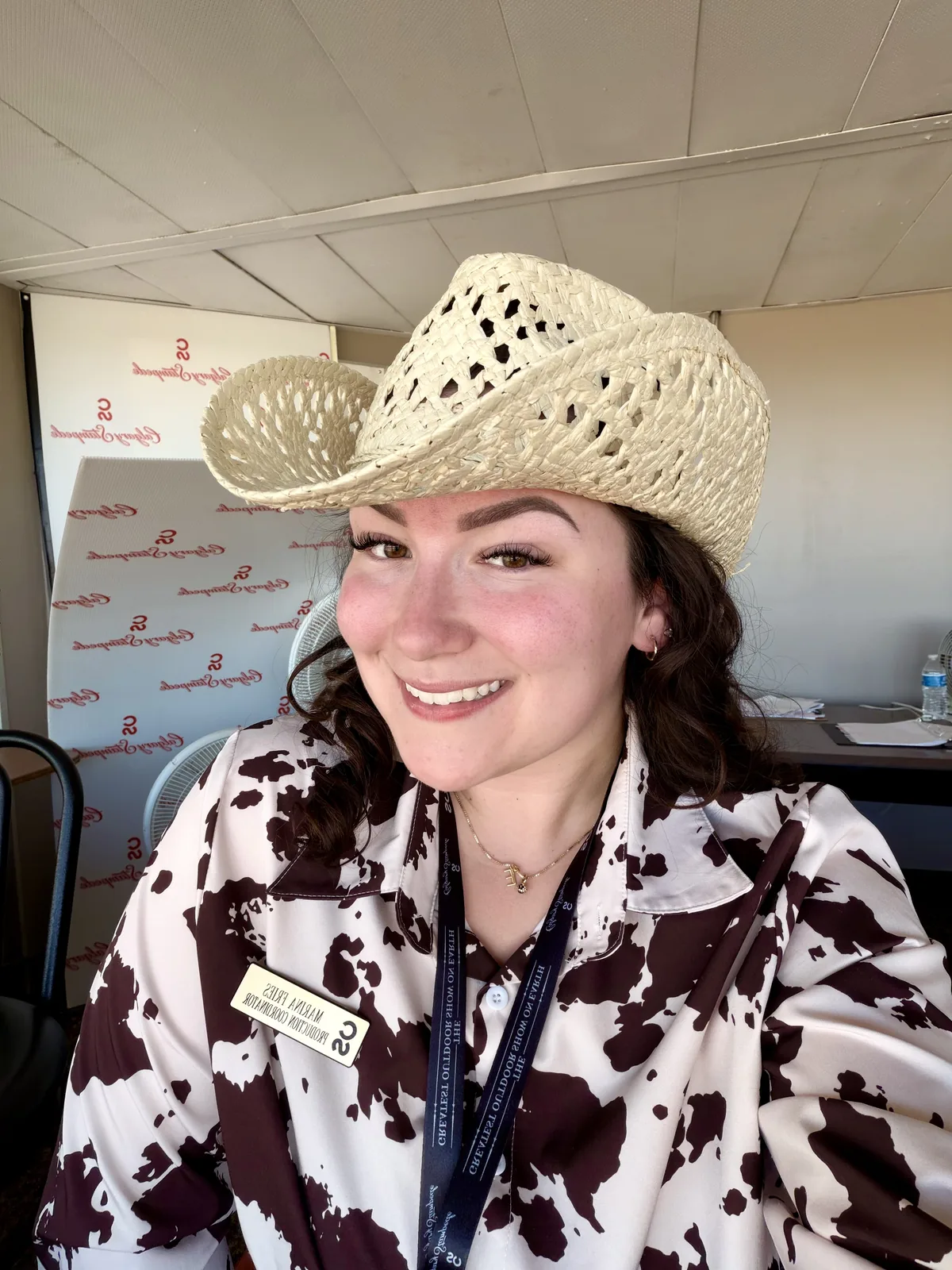 Production coordinator in a straw hat at the Calgary Stampede
