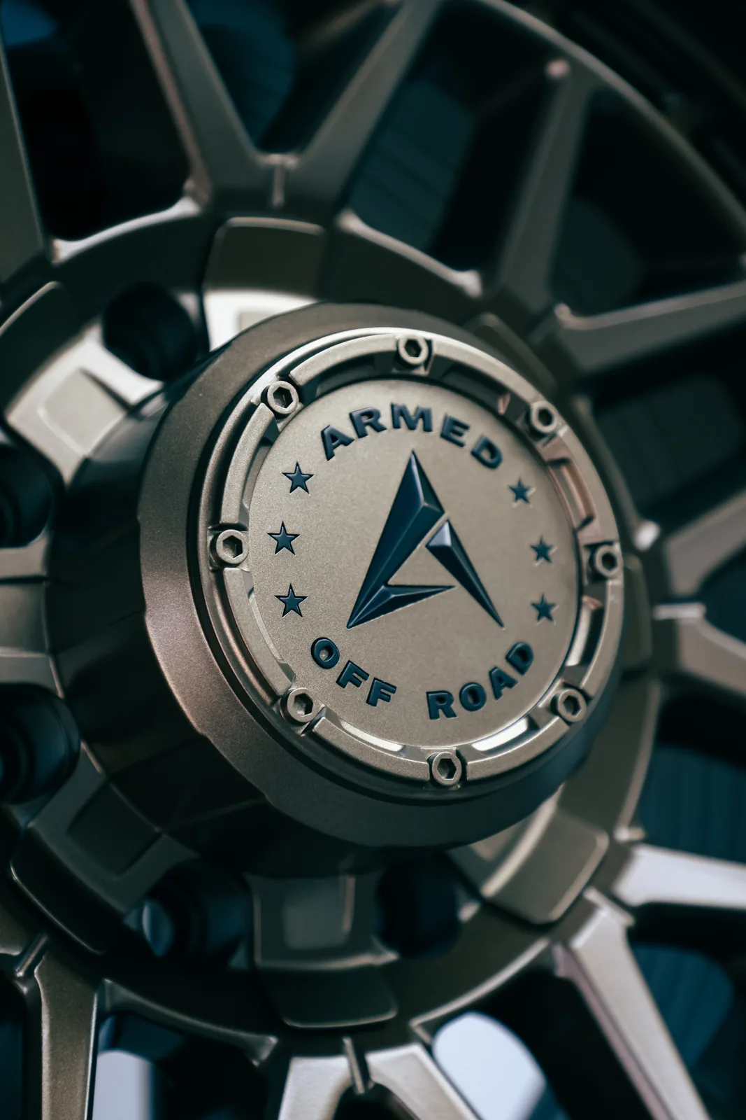 Close-up of an off-road wheel centre cap with an embossed logo