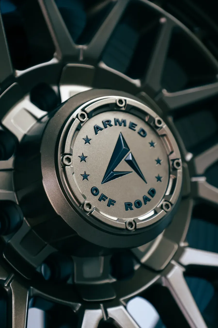 Close-up of an off-road wheel centre cap with an embossed logo